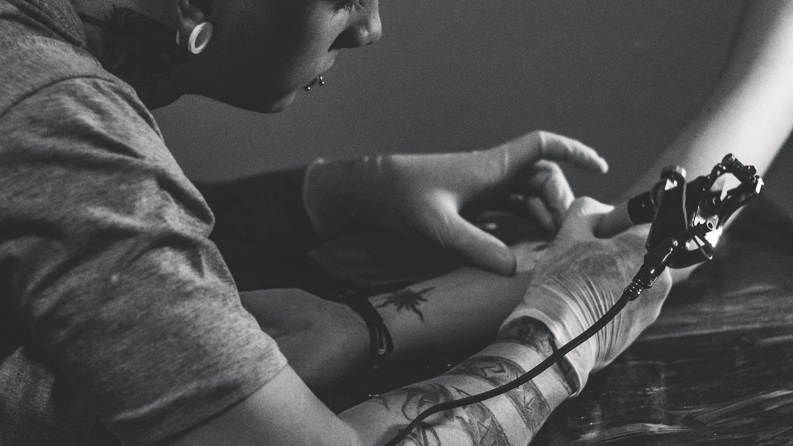 Tatuatore che impugna una macchinetta